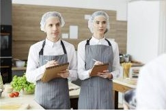 Hospitality professionals reviewing kitchen operations